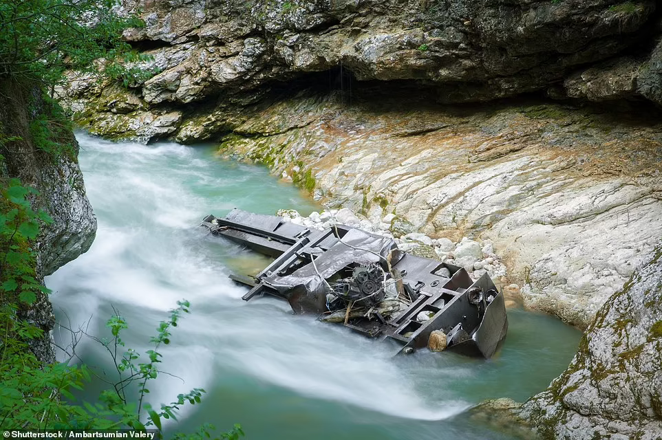 An old locomotive lies at the bottom of a mountain river close to an old narrow-gauge railway in the Guam Gorge in Adygea in the Caucasus region . Photo: Shutterstock 