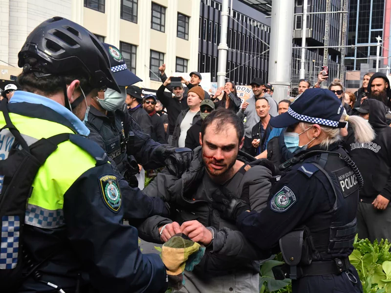 Police arrest a protester at a demonstration at Sydney Town Hall during an anti-lockdown rally on Saturday. Mick Tsikas/AP