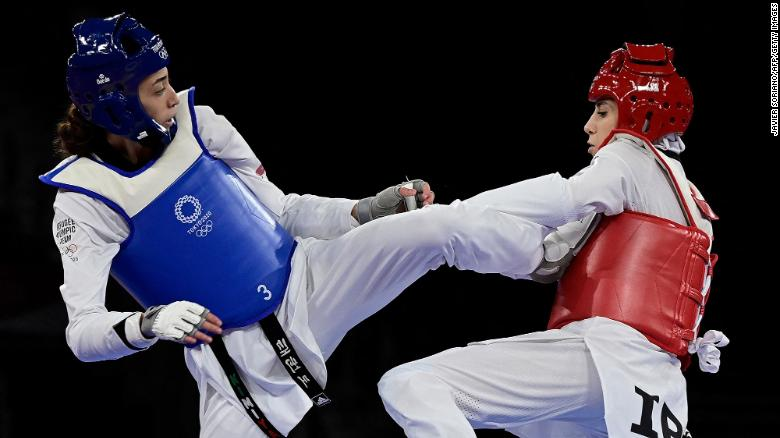 Refugee Olympic Team's Kimia Alizadeh (Blue) and Iran's Nahid Kiyani Chandeh (Red) compete in the taekwondo women's -57kg elimination round bout during the Tokyo 2020 Olympic Games at the Makuhari Messe Hall in Tokyo on July 25, 2021. Photo: CNN