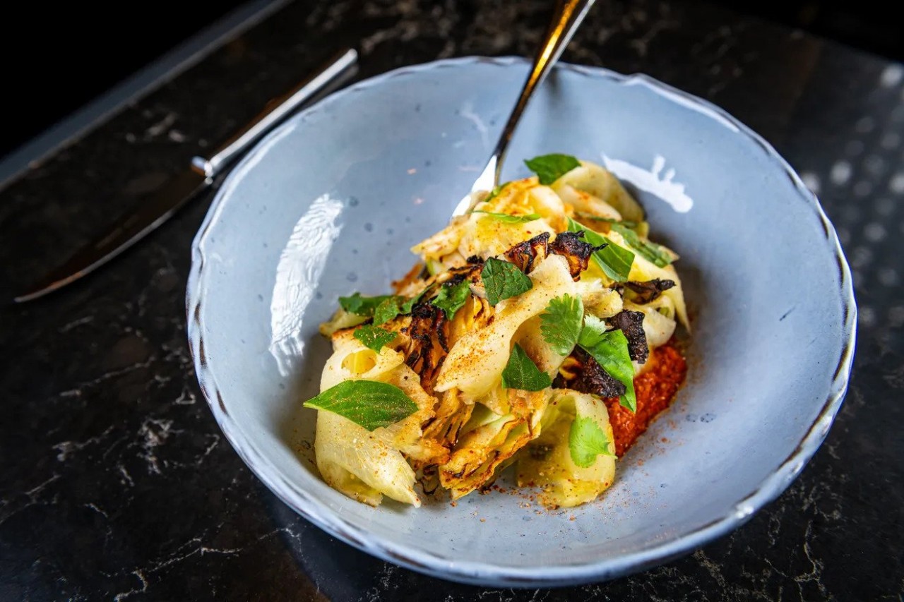 Charred Carafalex cabbage at Moon Rabbit comes with slices of pineapple and a spicy peanut romesco sauce meant to evoke bún bò huế Rey Lopez/Eater D.C.