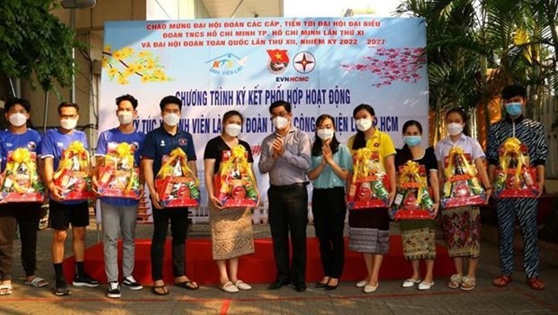 A leader of HCM City Power Corporation presents Tet gifts to Lao and Cambodian students on the occasion of Tet. (Photo: VNA