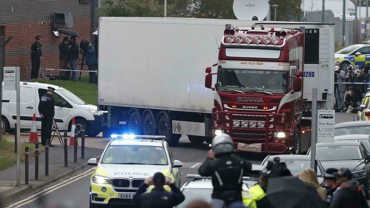 Police escort the truck that was found to contain a large number of dead bodies on an industrial estate in Thurrock, England, on October 23, 2019. © Alastair Grant, AP