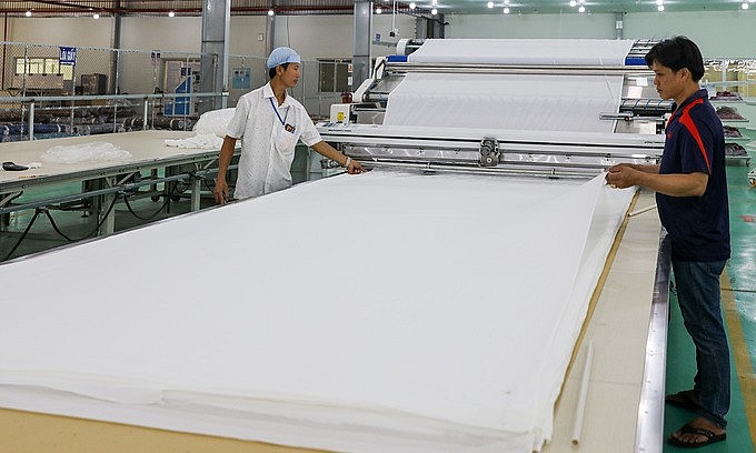 Workers at a textile factory in Vietnam's southern province of Long An, February 2020. Textile is on the list of industries expected to benefit from the new free trade deal between Vietnam and the U.K. Photo by VnExpress