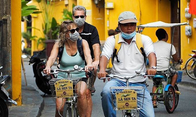 Foreign tourists with a hotel guide in Hoi An, March 18, 2020. Photo by VnExpress