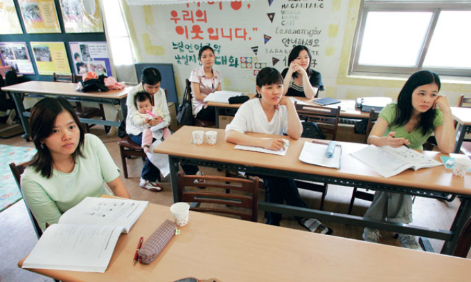 Vietnamese women attend a Korean class at the Women Migrants Human Rights Center in Seoul, South Korea. Photo by Reuters/Jo Yong-Hak