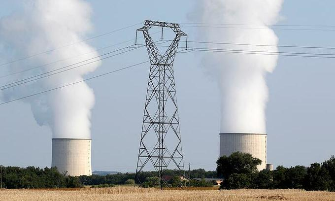 Cooling towers and high-tension electrical power lines are seen near the Golfech nuclear plant on the border of the Garonne River between Agen and Toulouse, France, August 29, 2019. Photo by Reuters/Regis Duvignau.