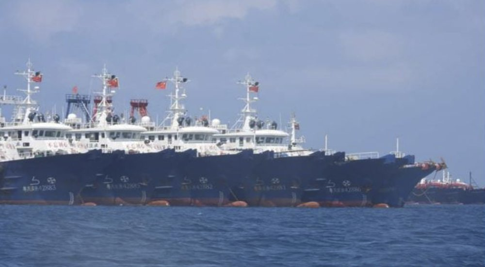 In this March 7, 2021, photo provided by the Philippine Coast Guard/National Task Force-West Philippine Sea, some of the 220 Chinese vessels are seen moored at Whitsun Reef, South China Sea. The Philippine government expressed concern after spotting more than 200 Chinese fishing vessels it believed were crewed by militias at a reef claimed by both countries in the South China Sea, but it did not immediately lodge a protest. (Philippine Coast Guard/National Task Force-West Philippine Sea via AP)