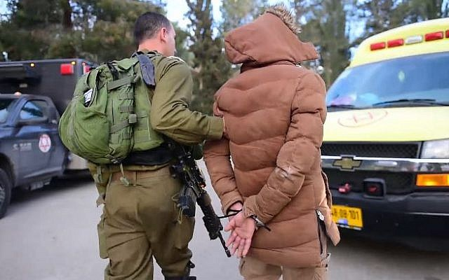 Illustrative: An Israeli soldier arresting a suspect after a raid in the West Bank city of Nablus, on March 18, 2018. (Israel Defense Forces)