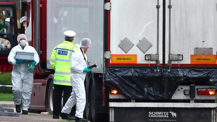 Police at the scene where bodies were discovered in the back of a truck in Essex.(Reuters