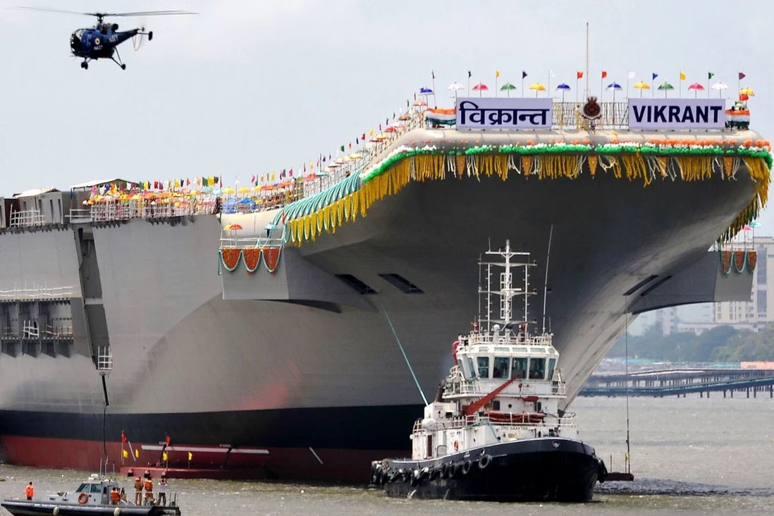 Tugboats guide India’s domestically-built aircraft carrier INS Vikrant as it leaves the Cochin Shipyard after its launch ceremony in 2013. Sea trials are expected to begin next month. Photo: AFP