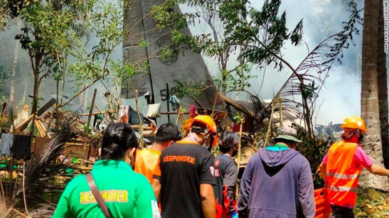 Rescuers search for bodies at the site where the plane crashed.