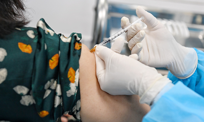 A medical worker receives a Covid-19 vaccine shot in Hanoi, March 8, 2021. Photo by VnExpress/Giang Huy.