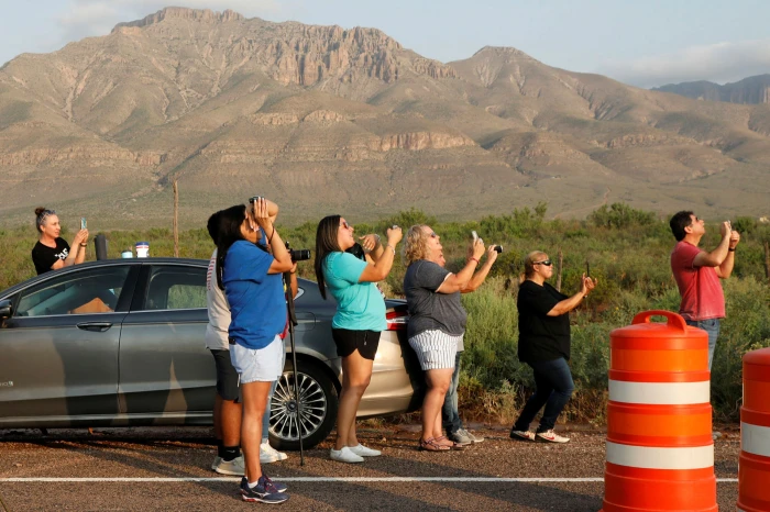 Spectators film the launch on their phones © Thom Baur/Reuters