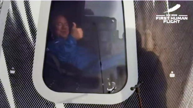 Jeff Bezos gives a thumbs-up inside the crew capsule moments after landing. BLUE ORIGIN