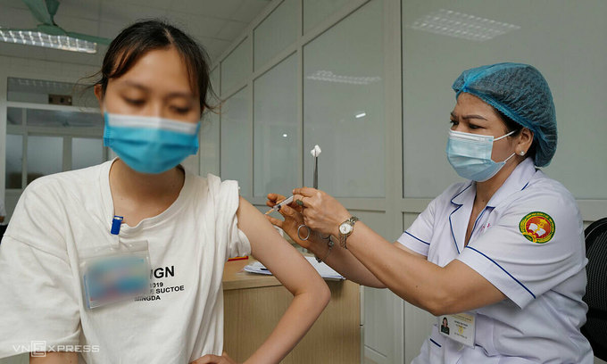 A woman receives a shot of the Nanocovax vaccine during a human trial phase in Hanoi, June 2021. Photo by VnExpress