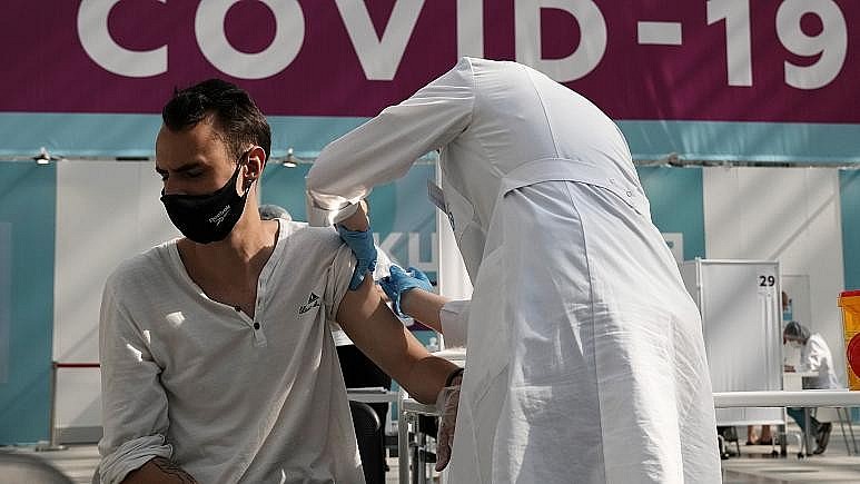 A medical worker administers a shot of Russia's Sputnik V coronavirus vaccine at a Moscow vaccination centre on July 12, 2021.