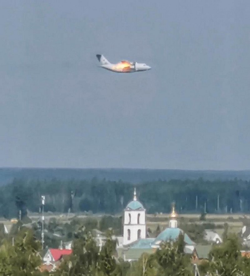 In this handout photo taken from video provided by Dmitry Ovchinnikov, The new light military transport burning plane Il-112V flies near Kubinka airfield about 45 kilometers (28 miles) west of Moscow, Russia, Tuesday, Aug. 17, 2021. The prototype military transport plane crashed while performing a test flight outside Moscow on Tuesday, Russian news agencies reported, citing Russia's United Aircraft Corporation. The new light military transport plane, Il-112V, crashed in a forested area as it was coming in for a landing at the Kubinka airfield about 45 kilometers (28 miles) west of Moscow, spokespeople of the corporation told the Tass news agency. (Dmitry Ovchinnikov via AP)