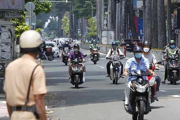 A police officer stands at a checkpoint on a street in HCM City (Photo: VNA)