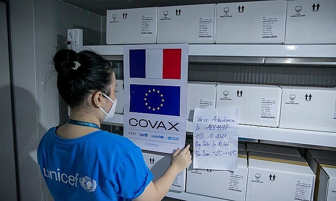 A worker handles batches of the AstraZeneca Covid-19 vaccine provided via global vaccine access mechanism Covax at a storage in Hanoi. Photo courtesy of UNICEF Vietnam