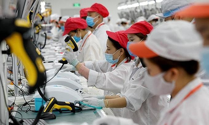 Laborers work at an assembly line to produce ventilators at Vsmart factory of conglomerate Vingroup outside Hanoi, August 3, 2020. Photo by Reuters