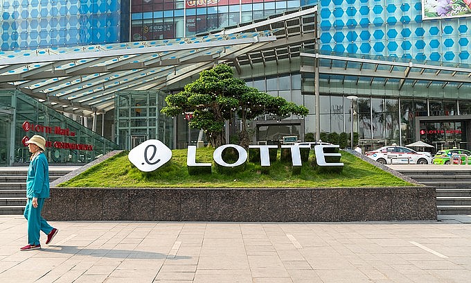 A person walks by Lotte Tower in Hanoi. Photo by Shutterstock/Vietnam Stock Images.