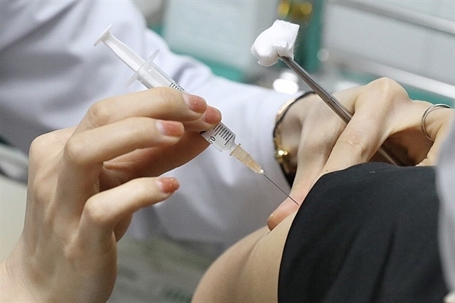 Vietnamese volunteers get the second shot of Nano Covax vaccine in second trial phase