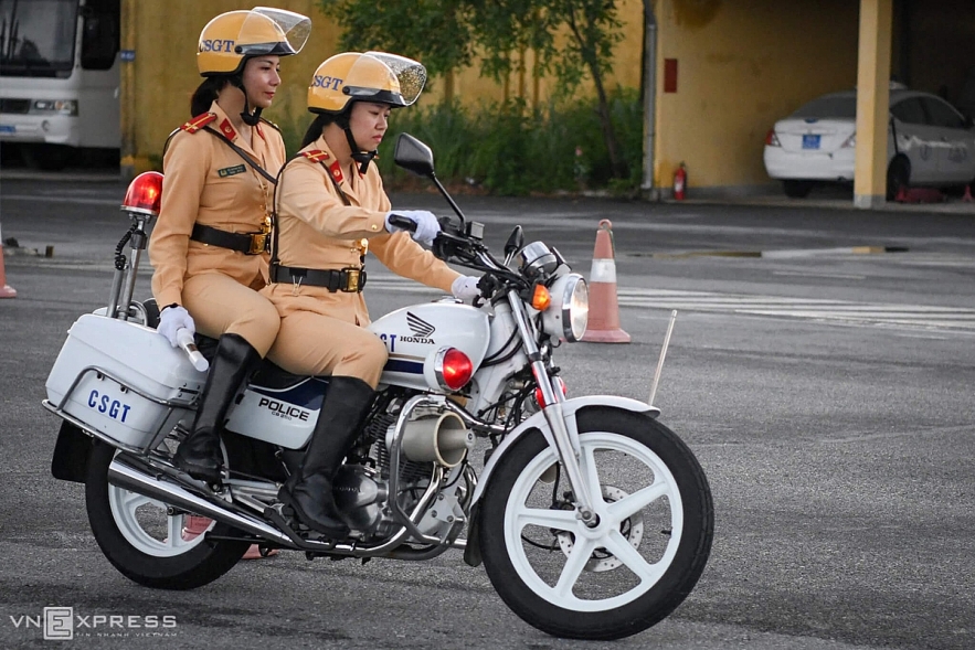 Vietnamese traffic police women exercise to lead groups of delegation by powerful motorcycles.