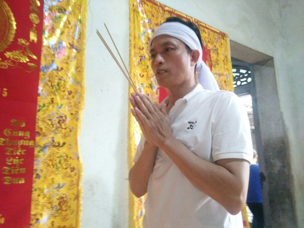 Mr. Tran Van Hai in front of his daughter's altar