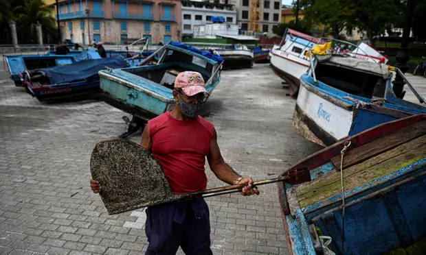 A fisherman secures his boat to land ahead of the passage of Tropical Storm Elsa in Havana. Photograph: Yamil Lage/AFP/Getty Images