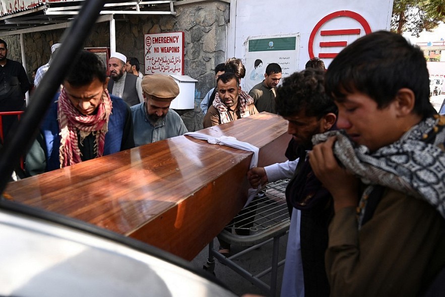 Relatives receive the remains of a victim of a double bombing in Kabul on August 26 AFP 