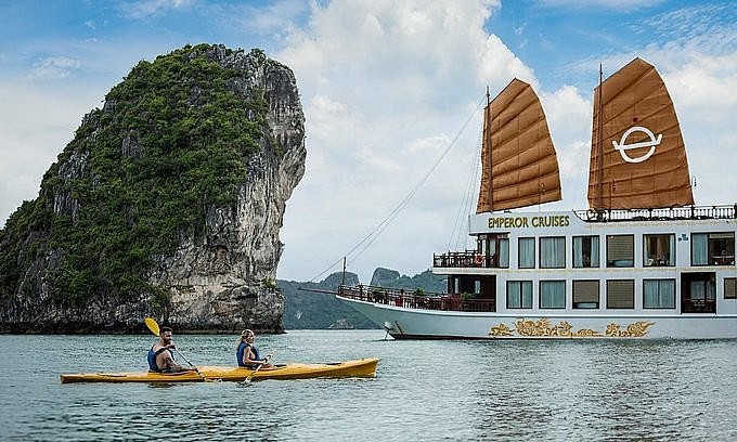 Foreign tourists sail kayak on Ha Long Bay, Quang Ninh Province. Photo: Lux Group