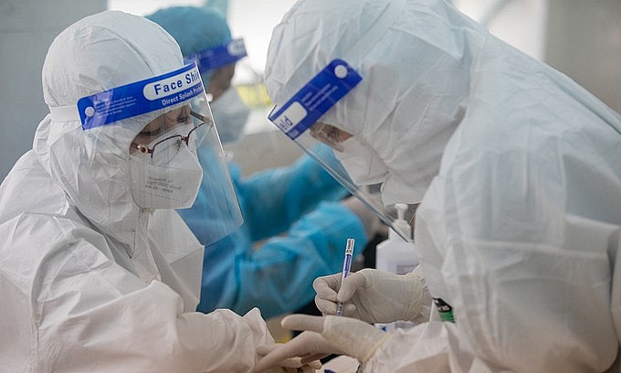 Health workers conduct Covid-19 vaccination at a high school in HCMC's District 1, October 27, 2021. Photo: VnExpress