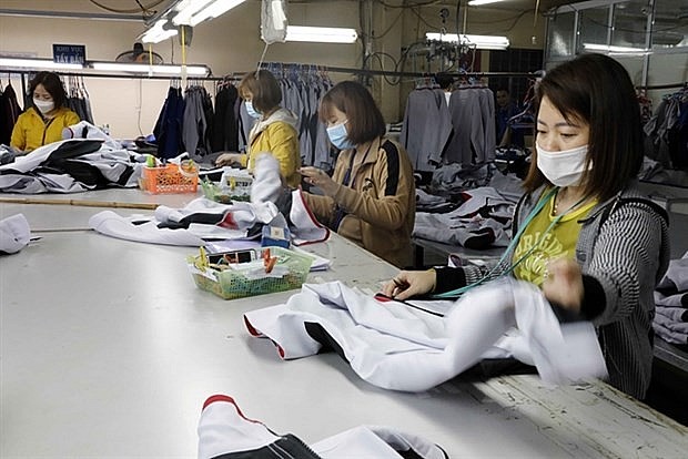 Production of workwear for export. Photo: VNA