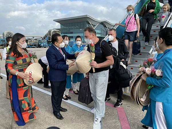 Foreign tourists arrive in Hanoi-based Noi Bai International Airport on the first international commercial flight on March 15, 2022 when Vietnam fully reopens international tourism.