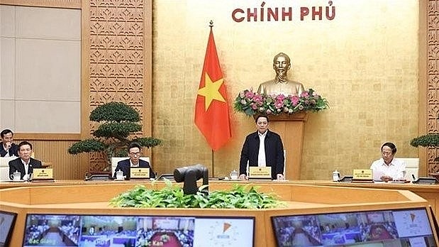 Prime Minister Pham Minh Chinh (standing) chairs the national teleconference on March 5. Photo: VNA