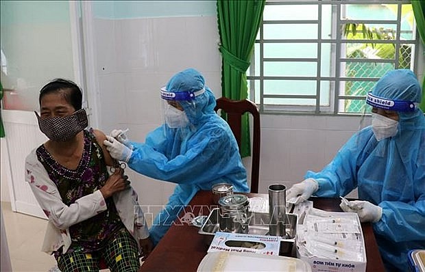 A resident in Tien Giang province receives a booster shot of Covid-19 vaccine. Photo: VNA