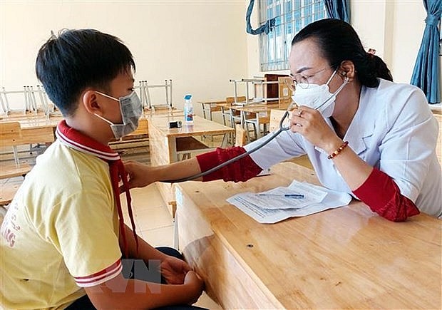 An under-12 student has his health checked-up before getting vaccinated against Covid-19. Photo: VNA