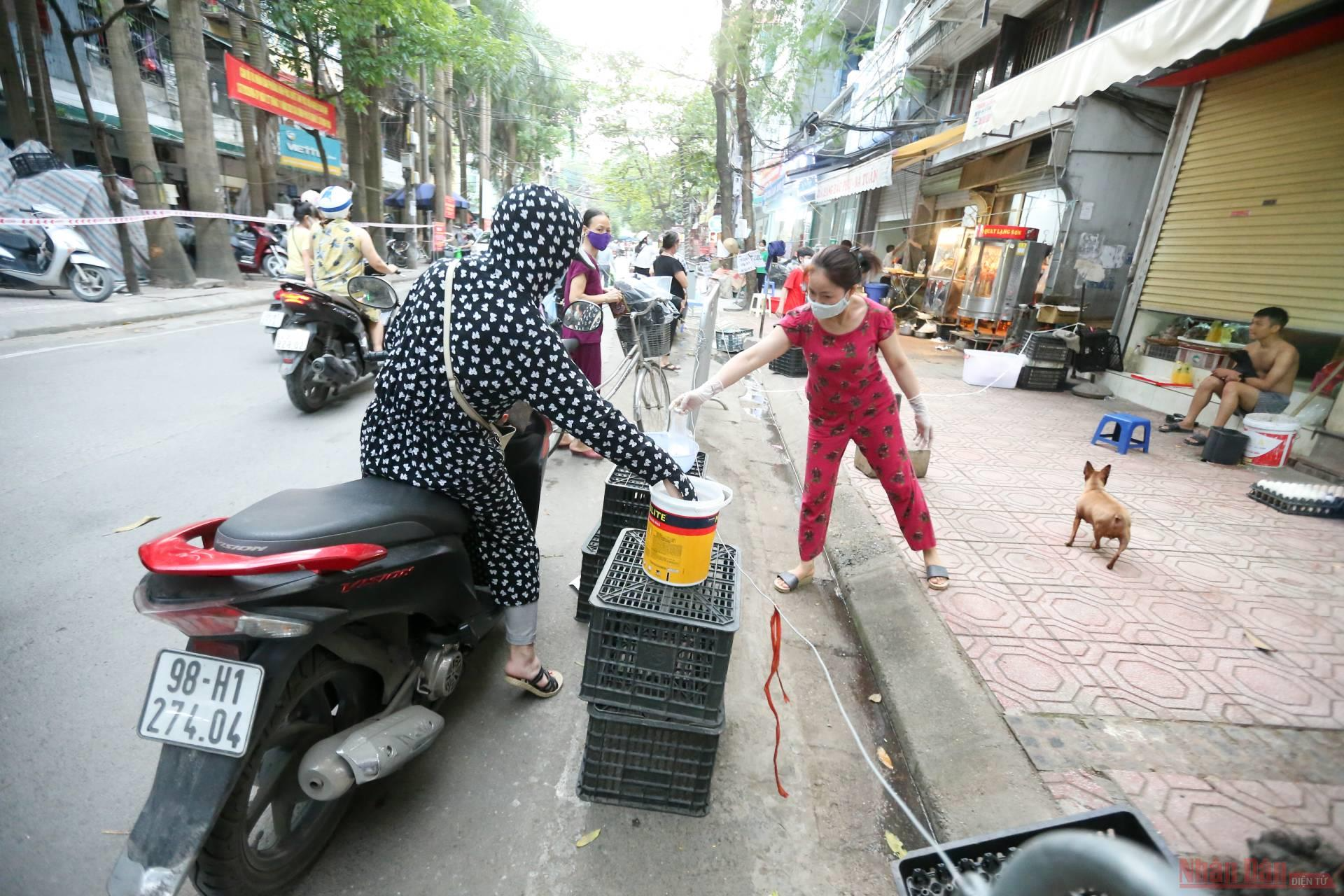 In photo: Shopping in Covid-19 - Put money in bucket, goods in pot