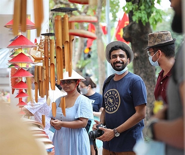 Foreign tourists attend a tourism festival near Hoan Kiem Lake in Hanoi. Photo: VNA