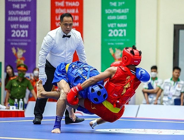 Vietnamese wushu artist Bui Truong Giang (in blue) defeats Jumanta from Indonesia to triumph the men's sanda 60kg on May 15. Photo: VNA