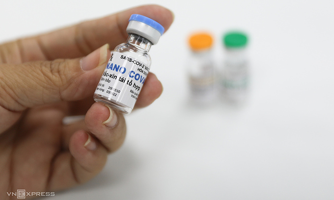 A researcher holds up a vial containing the Vietnamese Nanocovax Covid-19 vaccine at a production facility in HCMC. Photo: VnExpress
