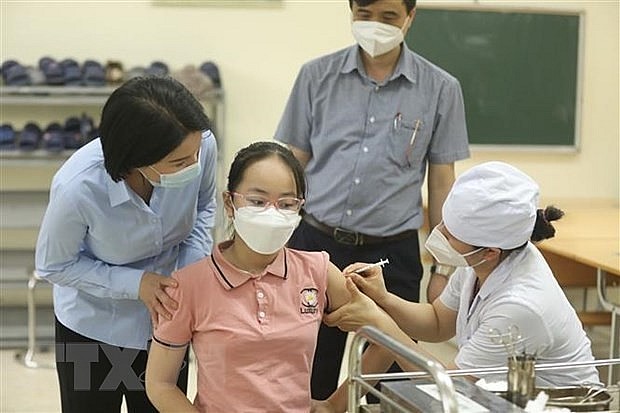 A student gets vaccinated against Covid-19. Photo: VNA
