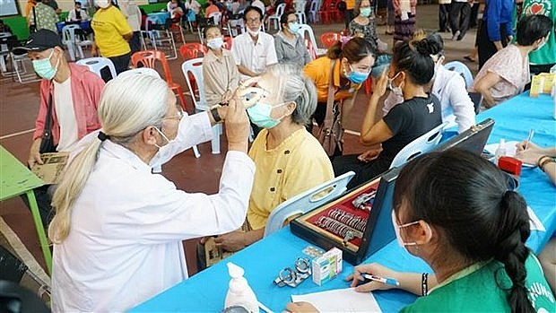 Doctors provide free health check-ups for OVs and Lao people. Photo: VNA