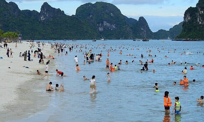 People swim at Hon Gai beach in Ha Long, Quang Ninh Province, July 2021. Photo: VnExpress