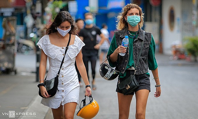 Foreign tourists walk on Bui Vien backpacker street in downtown HCMC, March 2020. Photo: VnExpress