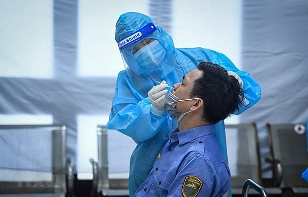 A medical worker takes sample for Covid-19 testing. Photo: VNA