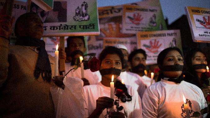 Indian activists take part in a vigil to mark the second anniversary of the fatal gang-rape of a student in New Delhi on December 16, 2014