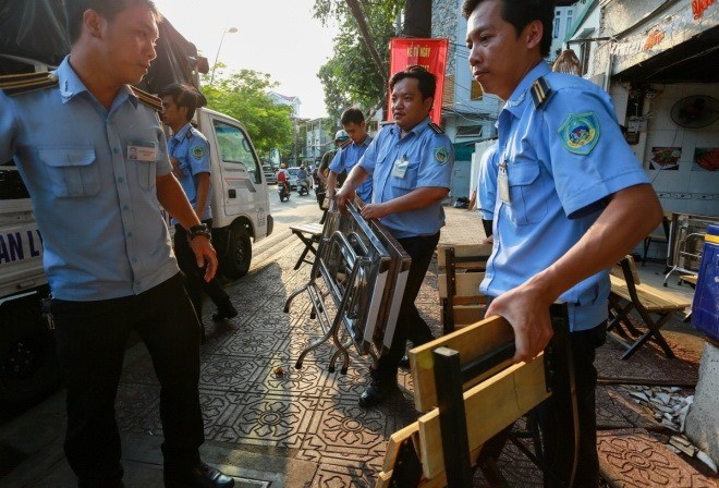 Hanoi joins HCMC to clear sidewalks of cars, beer joints