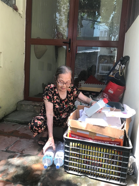 Elderly woman shows trash can mean cash