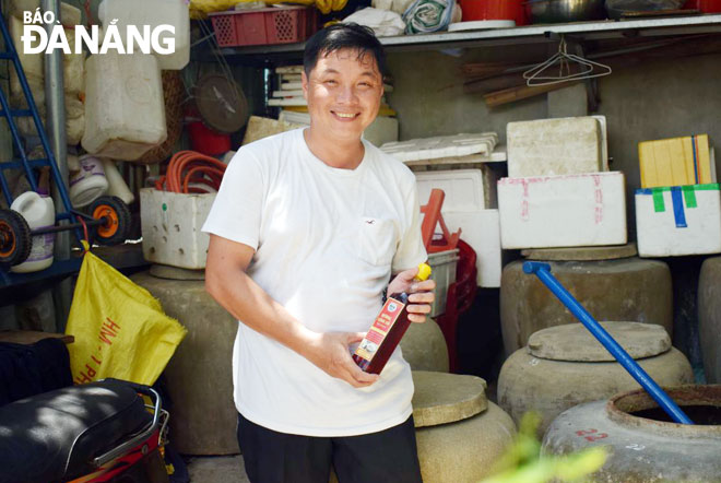 Men devoted to preserving tradition craft of Nam O fish sauce making